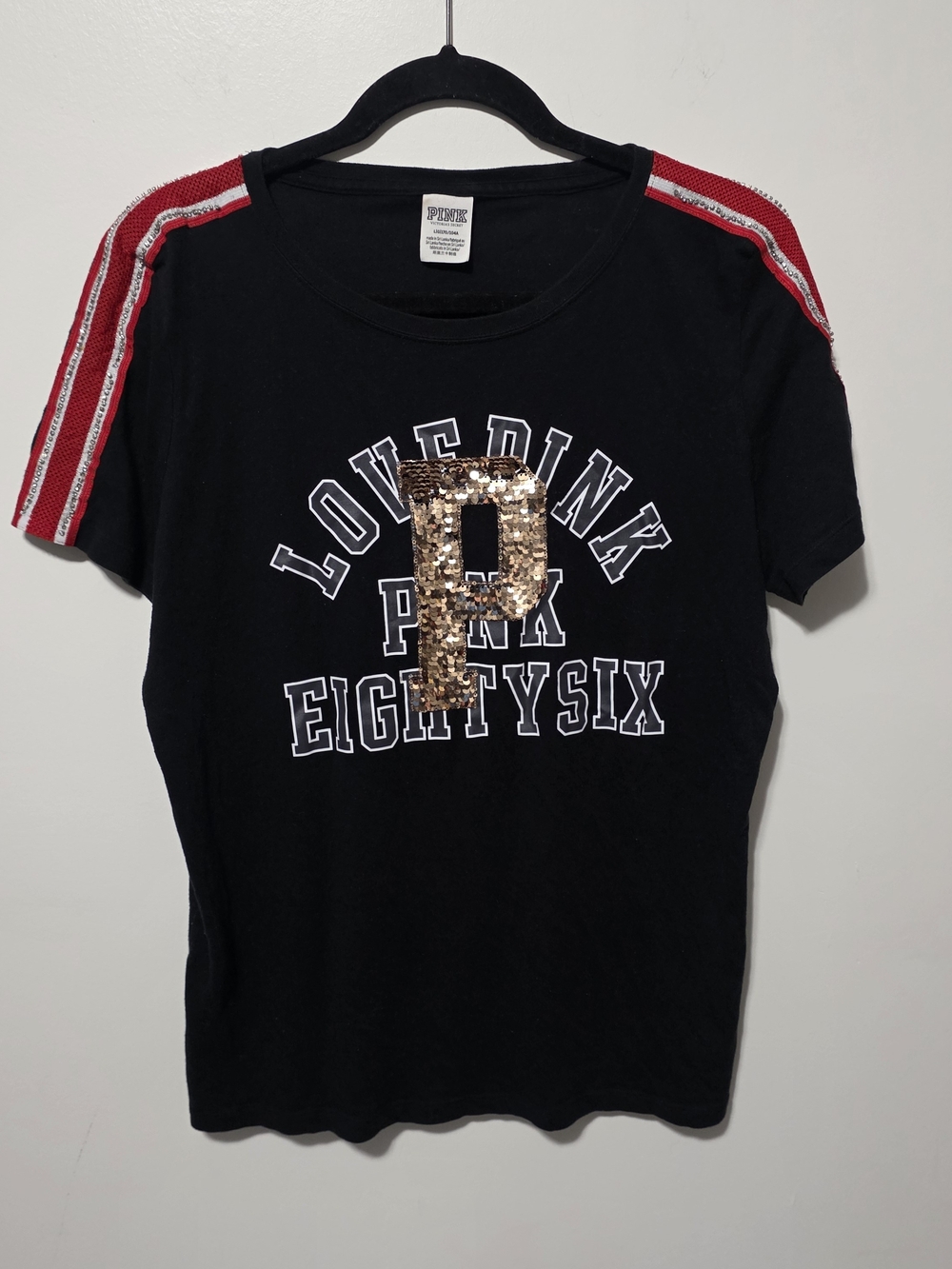 PINK Victoria's Secret Black Tee with Gold Sequin P and Red Shoulder Stripes